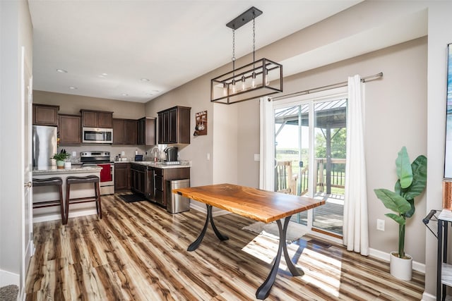 303 SE 14th St, Grimes, IA 50111 - dining space featuring wood finished floors and recessed lighting