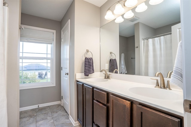 303 SE 14th St, Grimes, IA 50111 - full bath with double vanity and tile patterned floors