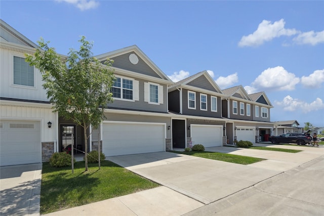3213 NW Linwood Ln, Ankeny, IA 50023 - townhome / multi-family property featuring a garage, concrete driveway, and stone siding