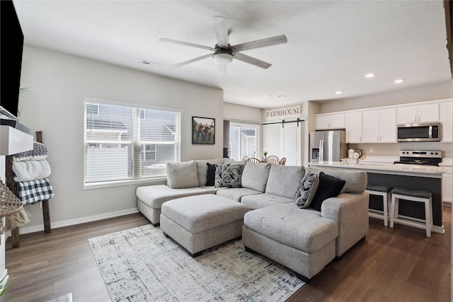 3213 NW Linwood Ln, Ankeny, IA 50023 - living room with a ceiling fan, dark wood finished floors, recessed lighting, and a barn door