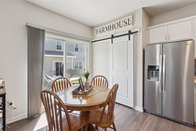 3213 NW Linwood Ln, Ankeny, IA 50023 - dining space with a barn door and wood finished floors
