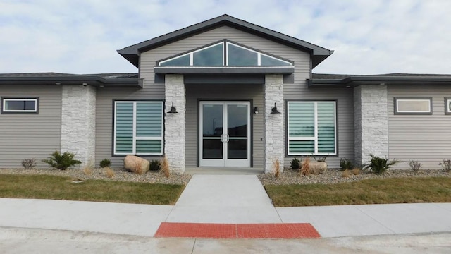 3213 NW Linwood Ln, Ankeny, IA 50023 - view of exterior entry featuring stone siding and french doors