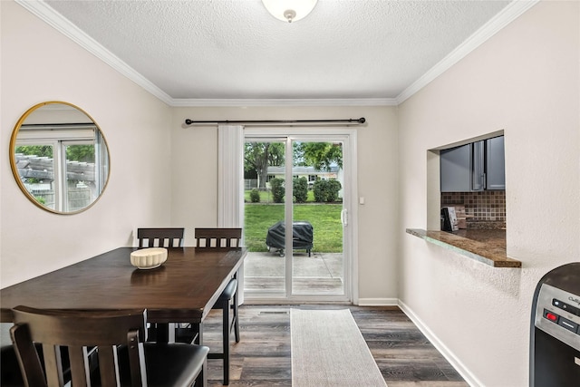 503 S Freeman St, Indianola, IA 50125 - dining area featuring a textured ceiling, dark wood-style floors, and crown molding