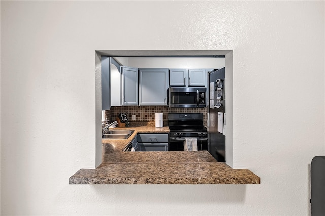 503 S Freeman St, Indianola, IA 50125 - kitchen featuring black electric range oven and tasteful backsplash
