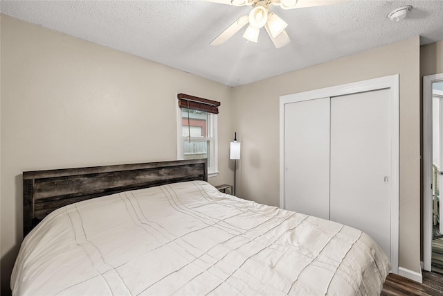 503 S Freeman St, Indianola, IA 50125 - bedroom with wood finished floors, a closet, ceiling fan, and a textured ceiling