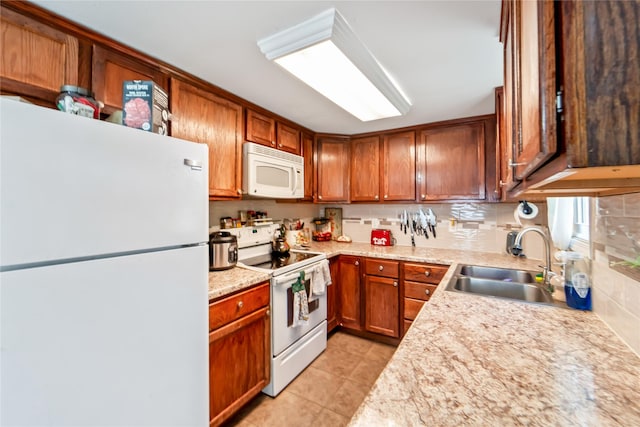 3935 8th St, Des Moines, IA 50313 - kitchen featuring white appliances, light countertops, light tile patterned floors, brown cabinetry, and backsplash