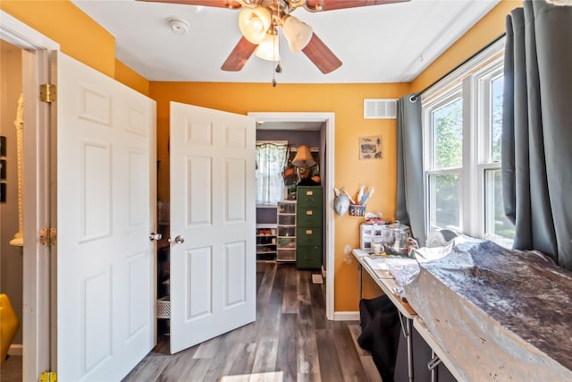 3935 8th St, Des Moines, IA 50313 - home office with ceiling fan and dark wood-style flooring
