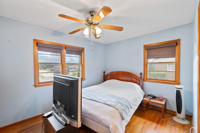 1232 Carrie Ave, Des Moines, IA 50315 - bedroom with wood finished floors and ceiling fan