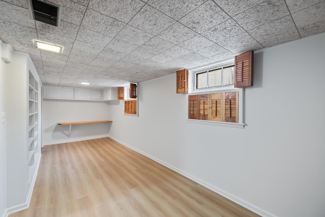 1232 Carrie Ave, Des Moines, IA 50315 - below grade area with wood finished floors and baseboards