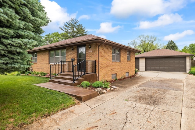 1232 Carrie Ave, Des Moines, IA 50315 - view of front of house with brick siding, a detached garage, a front lawn, and an outbuilding