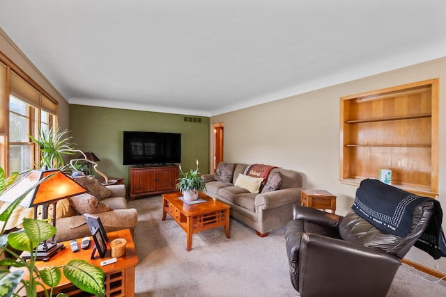 1232 Carrie Ave, Des Moines, IA 50315 - living area with built in shelves and carpet flooring