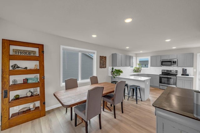 4412 NW 12th St, Ankeny, IA 50023 - dining area with light wood finished floors and recessed lighting