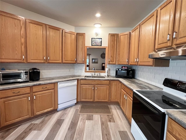8 Chancery Ct, Newton, IA 50208 - kitchen featuring electric range oven, dishwasher, black microwave, under cabinet range hood, and light wood-style floors