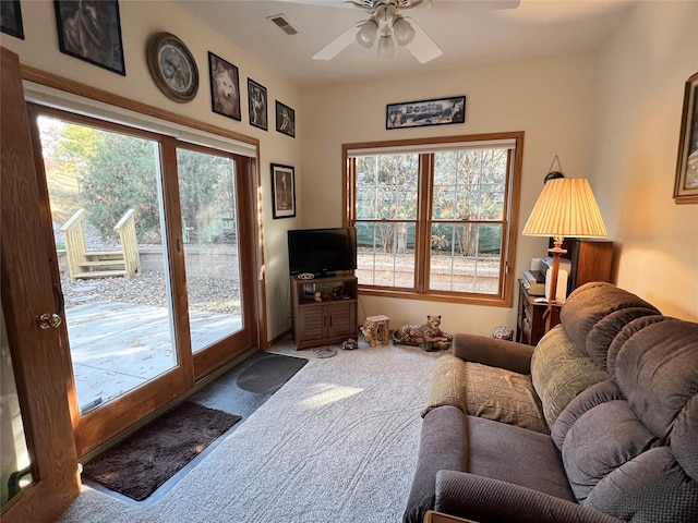 8 Chancery Ct, Newton, IA 50208 - carpeted living area with ceiling fan and healthy amount of natural light