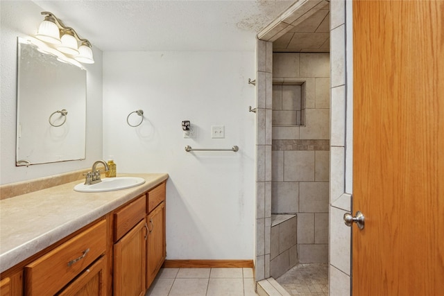 106 NW Scott St, Ankeny, IA 50023 - bathroom featuring vanity, a tile shower, and tile patterned floors