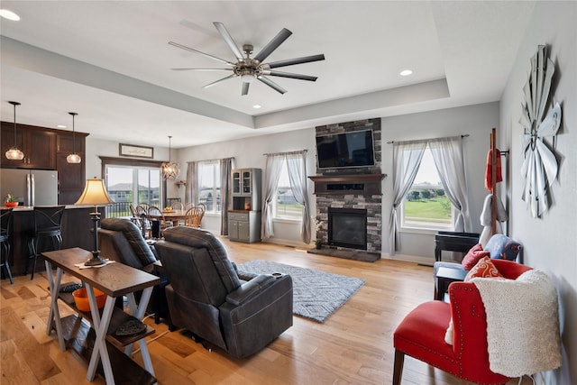 1609 NW Prairie Creek Dr, Grimes, IA 50111 - living area featuring a raised ceiling, healthy amount of natural light, a ceiling fan, and recessed lighting