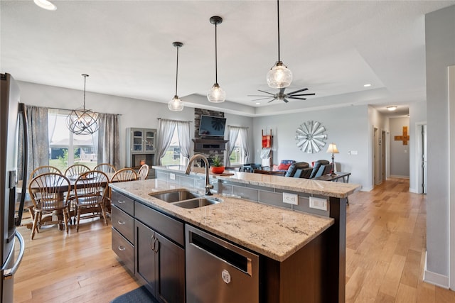 1609 NW Prairie Creek Dr, Grimes, IA 50111 - kitchen featuring stainless steel appliances, open floor plan, an island with sink, a ceiling fan, and healthy amount of natural light