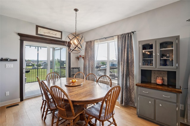 1609 NW Prairie Creek Dr, Grimes, IA 50111 - dining space featuring light wood-type flooring and a chandelier