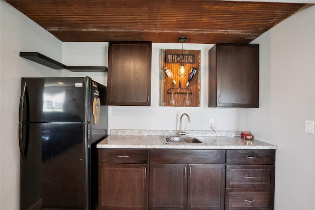 1609 NW Prairie Creek Dr, Grimes, IA 50111 - kitchen with freestanding refrigerator, wooden ceiling, dark brown cabinets, light countertops, and pendant lighting