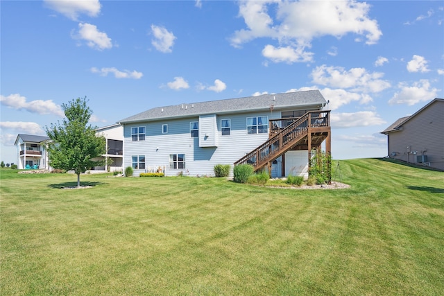 1609 NW Prairie Creek Dr, Grimes, IA 50111 - back of house with stairway, a wooden deck, a lawn, and a garage