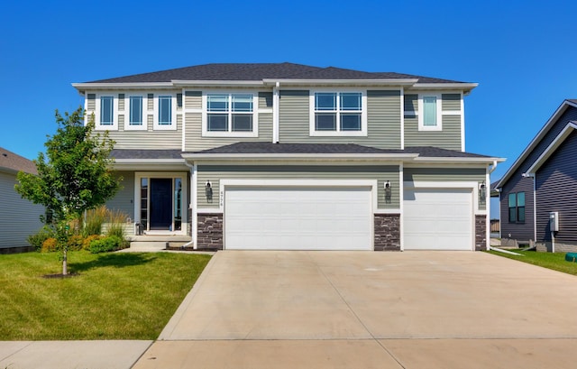 4774 172nd Way, Urbandale, IA 50323 - view of front of property featuring an attached garage, concrete driveway, a front yard, and stone siding