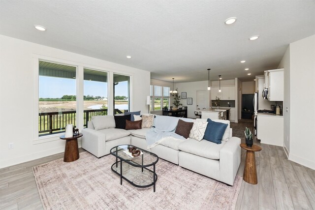 4774 172nd Way, Urbandale, IA 50323 - living room featuring light wood-style flooring and recessed lighting
