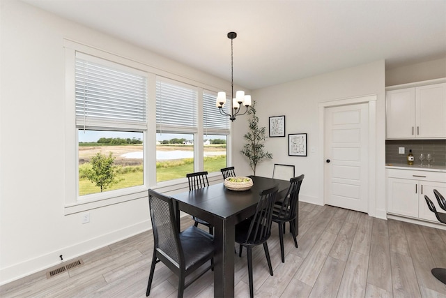 4774 172nd Way, Urbandale, IA 50323 - dining area with a chandelier and light wood finished floors