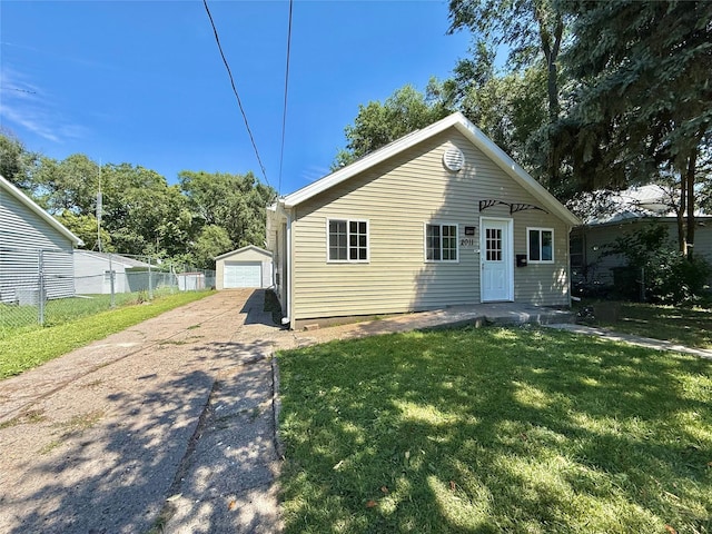 2011 E 23rd St, Des Moines, IA 50317 - bungalow-style house featuring a detached garage, an outbuilding, and driveway