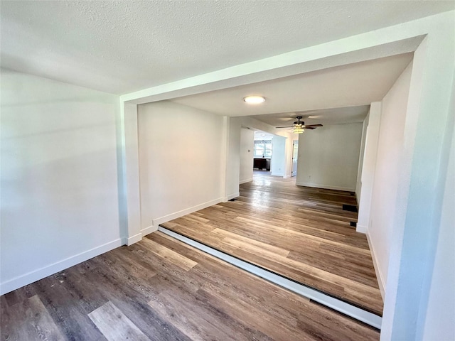 2011 E 23rd St, Des Moines, IA 50317 - unfurnished room featuring wood finished floors, a textured ceiling, and a ceiling fan