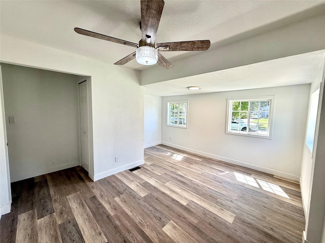 2011 E 23rd St, Des Moines, IA 50317 - unfurnished bedroom with wood finished floors, a closet, and ceiling fan