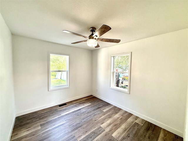 2011 E 23rd St, Des Moines, IA 50317 - unfurnished room with healthy amount of natural light, wood finished floors, and a ceiling fan