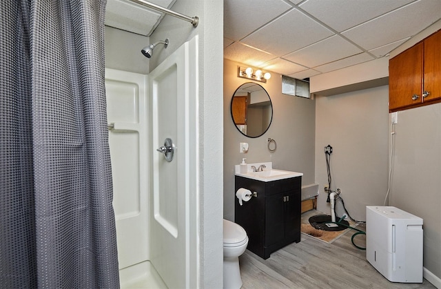 1802 W 5th Ave, Indianola, IA 50125 - bathroom featuring wood finished floors, a shower with shower curtain, a paneled ceiling, and vanity
