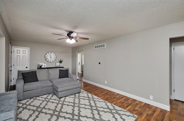1802 W 5th Ave, Indianola, IA 50125 - living room with wood finished floors, ceiling fan, and a textured ceiling