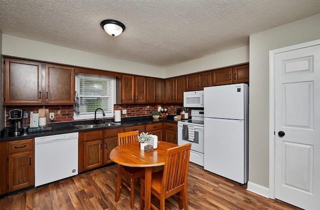 1802 W 5th Ave, Indianola, IA 50125 - kitchen featuring white appliances, backsplash, dark countertops, and a textured ceiling