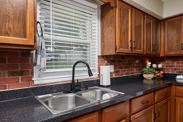 1802 W 5th Ave, Indianola, IA 50125 - kitchen with dark countertops, brown cabinets, and decorative backsplash