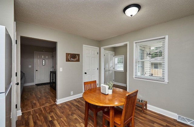 1802 W 5th Ave, Indianola, IA 50125 - dining area featuring wood finished floors and a textured ceiling