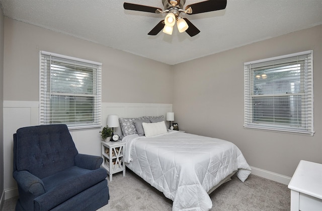 1802 W 5th Ave, Indianola, IA 50125 - carpeted bedroom with ceiling fan and a wainscoted wall