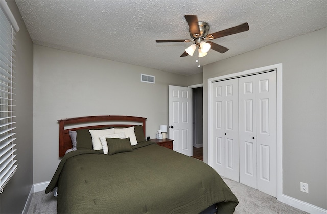 1802 W 5th Ave, Indianola, IA 50125 - bedroom with carpet flooring, a closet, ceiling fan, and a textured ceiling