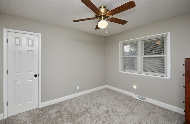 1802 W 5th Ave, Indianola, IA 50125 - empty room featuring carpet, a ceiling fan, and a textured ceiling