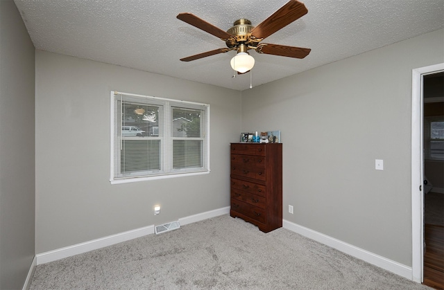 1802 W 5th Ave, Indianola, IA 50125 - bedroom featuring carpet flooring, a textured ceiling, and a ceiling fan