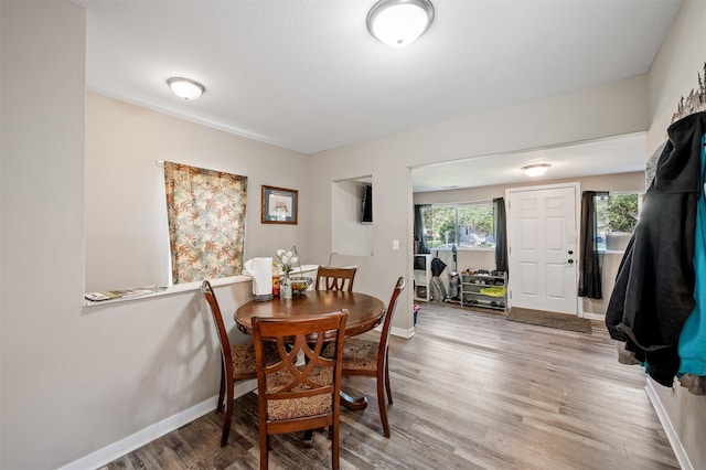 714 E 27th St, Des Moines, IA 50317 - dining room featuring baseboards and light wood-style flooring