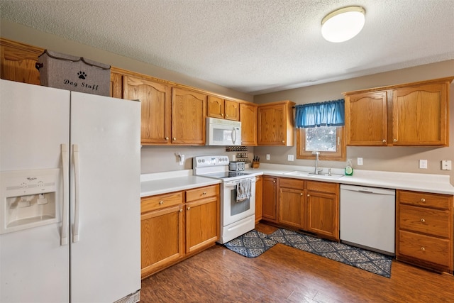 5428 NW 90th St, Johnston, IA 50131 - kitchen featuring white appliances, a textured ceiling, dark wood-type flooring, light countertops, and brown cabinets