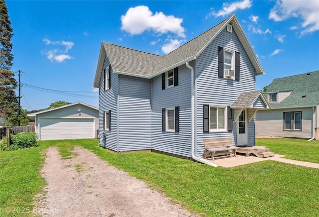 122 W Washington St, Colfax, IA 50054 - rear view of property with a shingled roof, an outdoor structure, and a detached garage