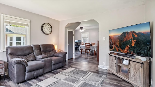 122 W Washington St, Colfax, IA 50054 - living room featuring arched walkways, dark wood-type flooring, and ceiling fan