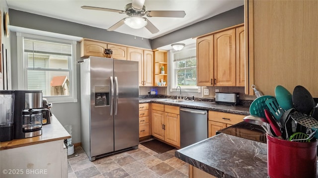 122 W Washington St, Colfax, IA 50054 - kitchen featuring stainless steel appliances, light brown cabinets, ceiling fan, and dark countertops