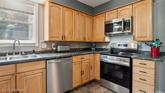 122 W Washington St, Colfax, IA 50054 - kitchen featuring stainless steel appliances, light brown cabinetry, and dark countertops