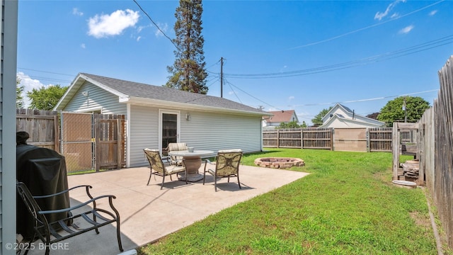 122 W Washington St, Colfax, IA 50054 - fenced backyard featuring a fire pit, a patio, and a gate