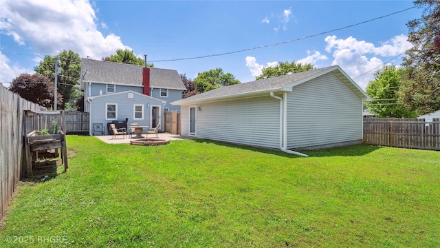 122 W Washington St, Colfax, IA 50054 - rear view of house featuring a fenced backyard, a fire pit, and a patio