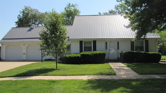 1401 N Grant St, Knoxville, IA 50138 - view of front of property featuring a garage, a front yard, concrete driveway, and a metal roof