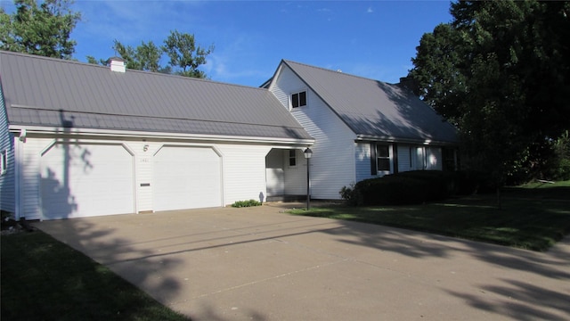 1401 N Grant St, Knoxville, IA 50138 - view of front facade with a chimney, a standing seam roof, and a metal roof